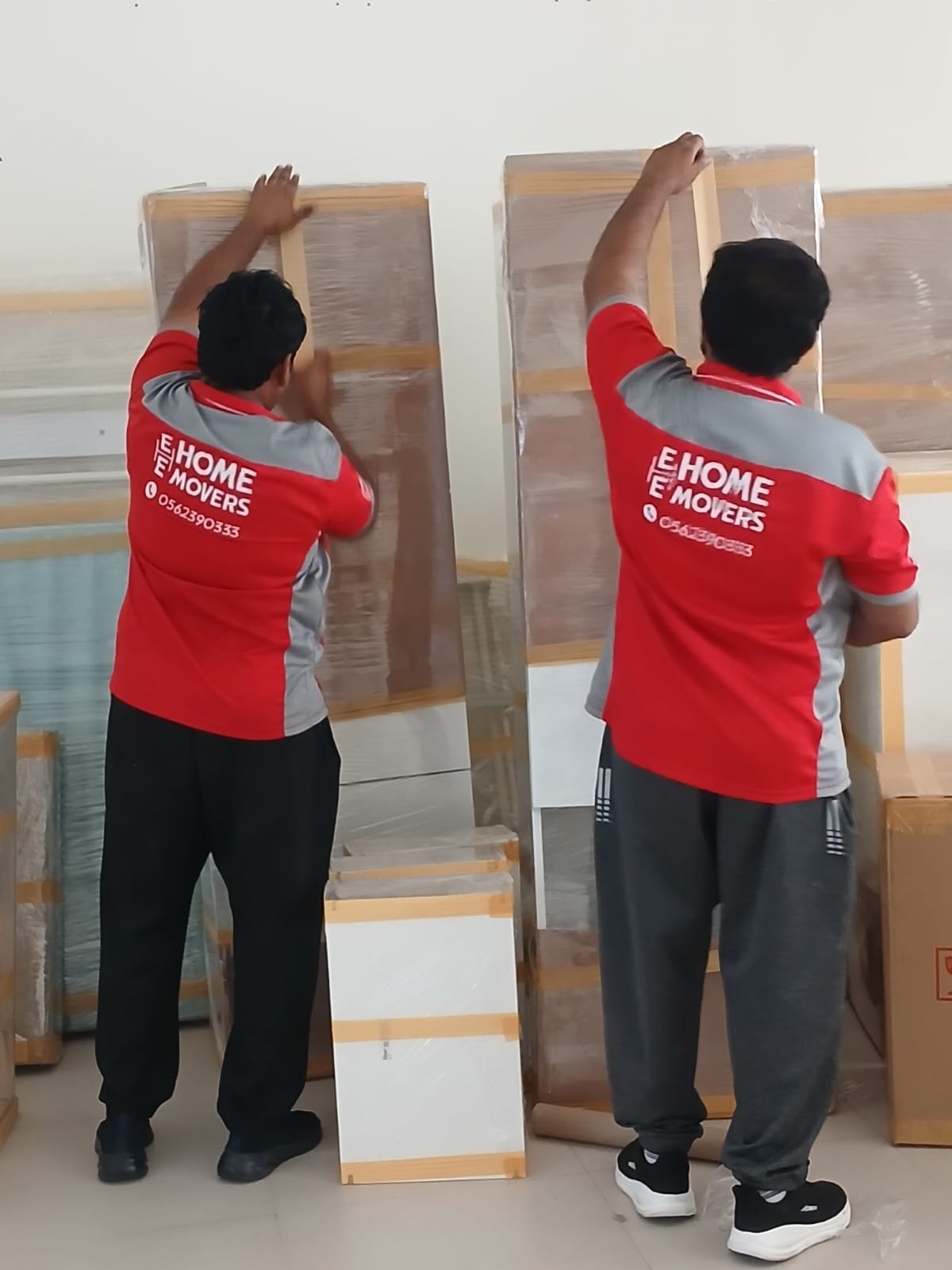 E-Home Movers team organizing boxes inside the moving truck